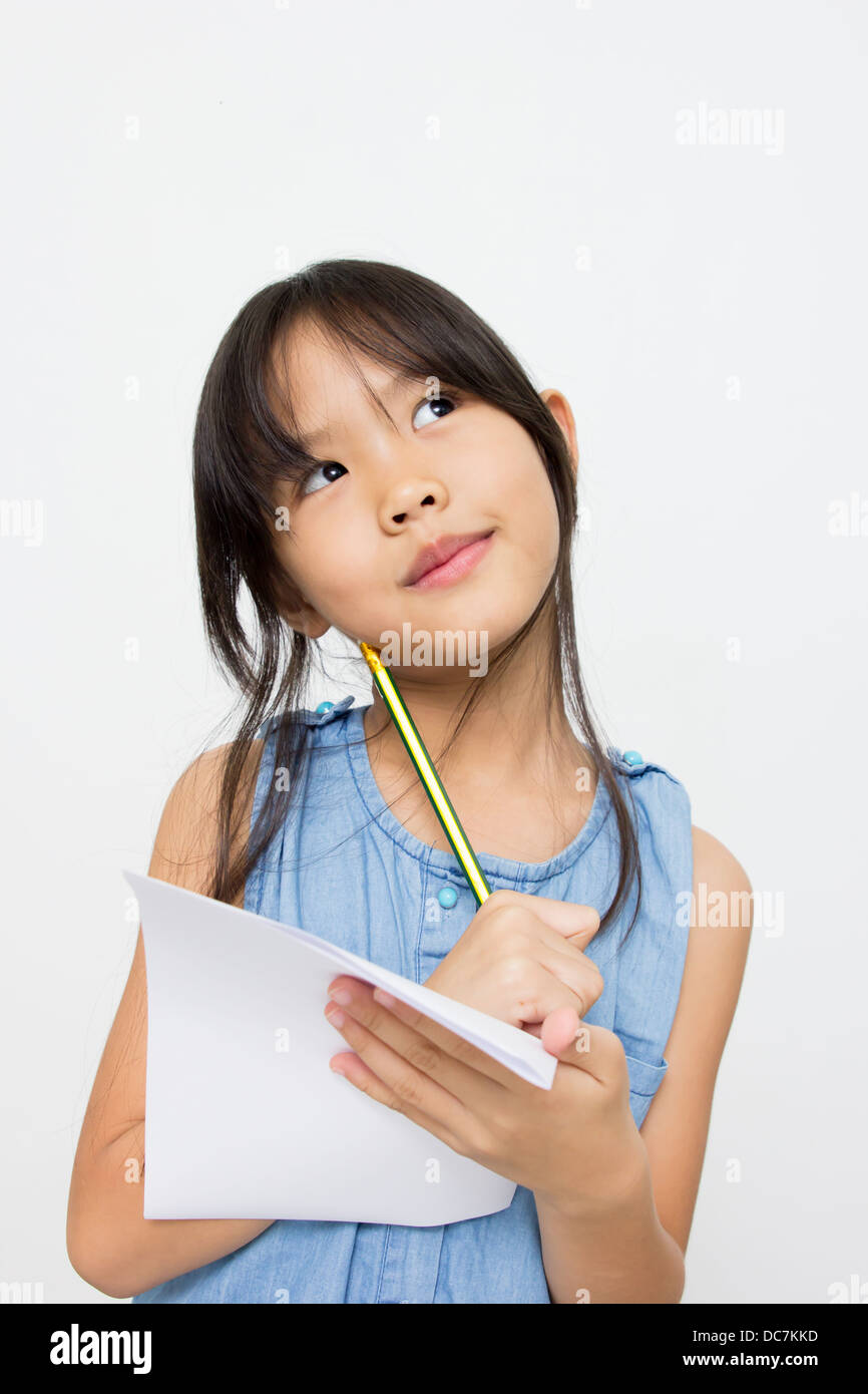 Portrait of a cute little asian girl thinking Stock Photo