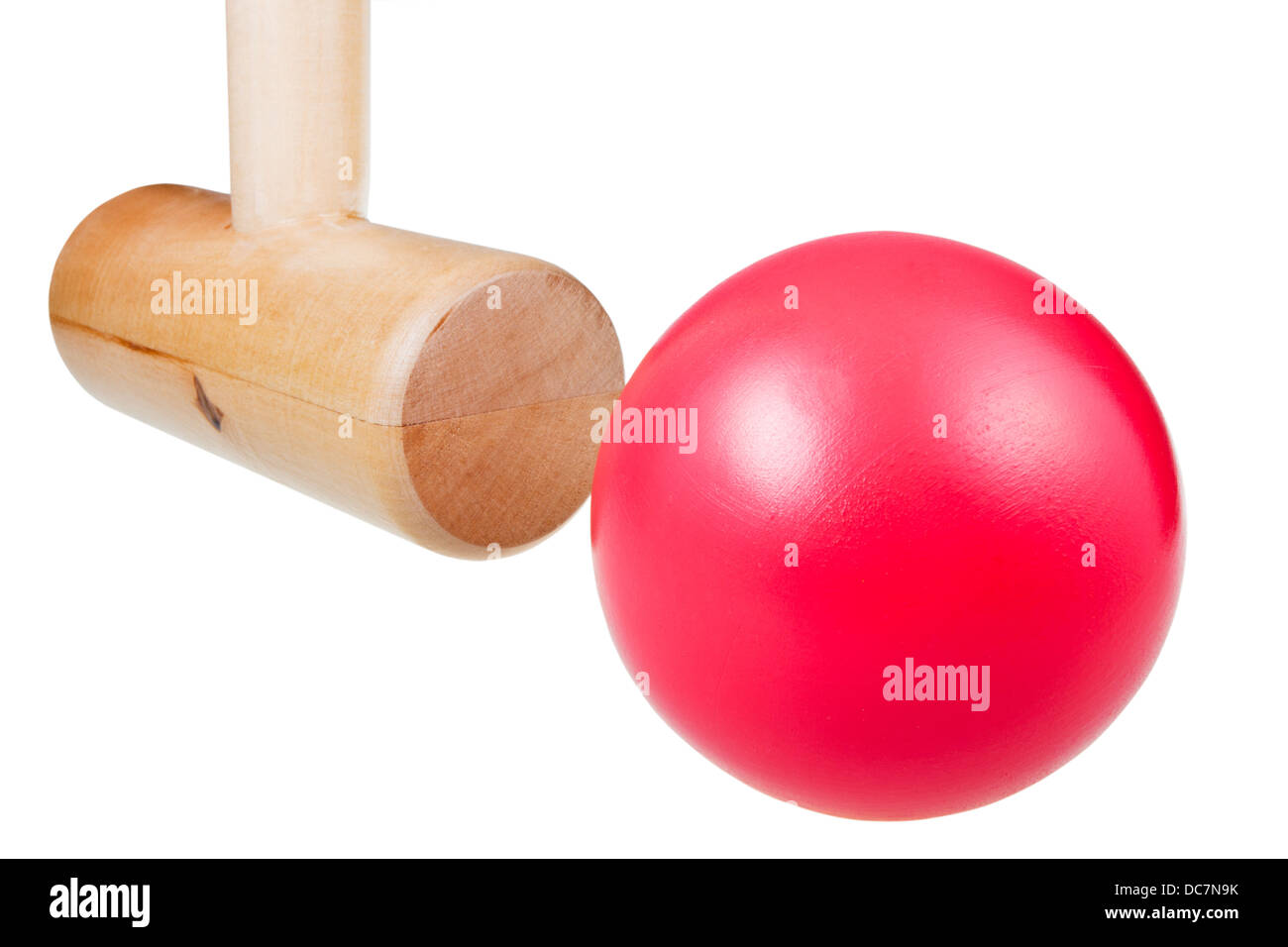 croquet wooden mallet strikes red ball close up isolated on white