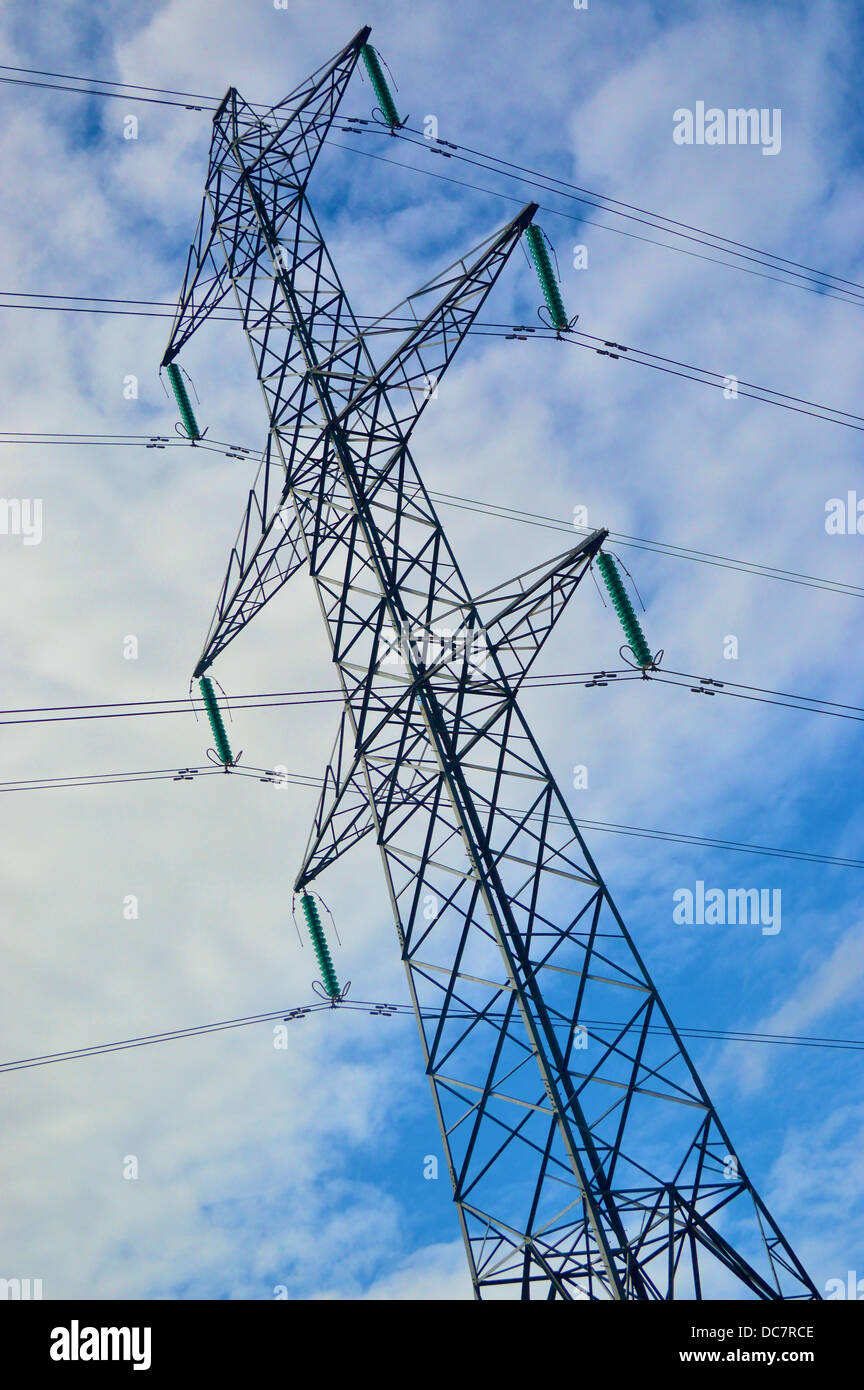 Electricity pylon against a cloudy blue sky Stock Photo - Alamy