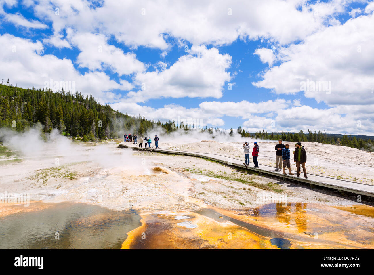 Tourists on the trail at Geyser Hill, Upper Geyser Basin, Yellowstone National Park, Wyoming, USA Stock Photo