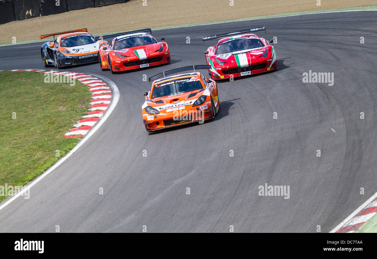 BritishGT race cars heading down Paddock Hill bend at Brands Hatch in the UK Stock Photo