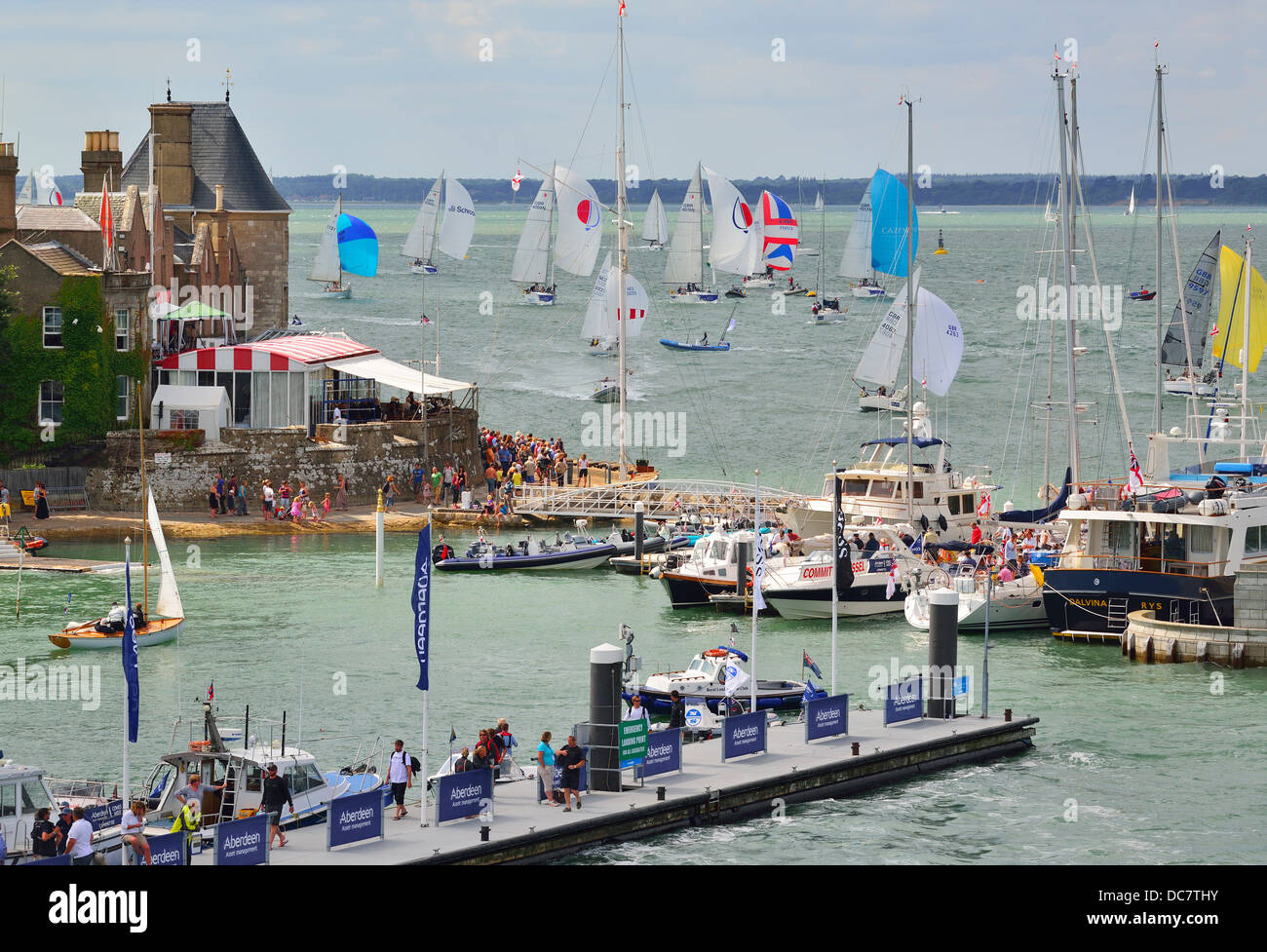 Racing Boats sailing to the finishing line at the Royal Yacht Squadron during Aberdeen Asset Management Cowes Week.Cowes, Isle of Wight, UK . Stock Photo