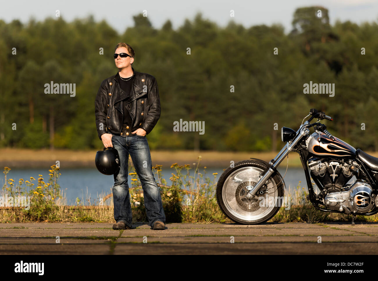 Young man wearing leather clothes with his Harley Davidson Stock Photo