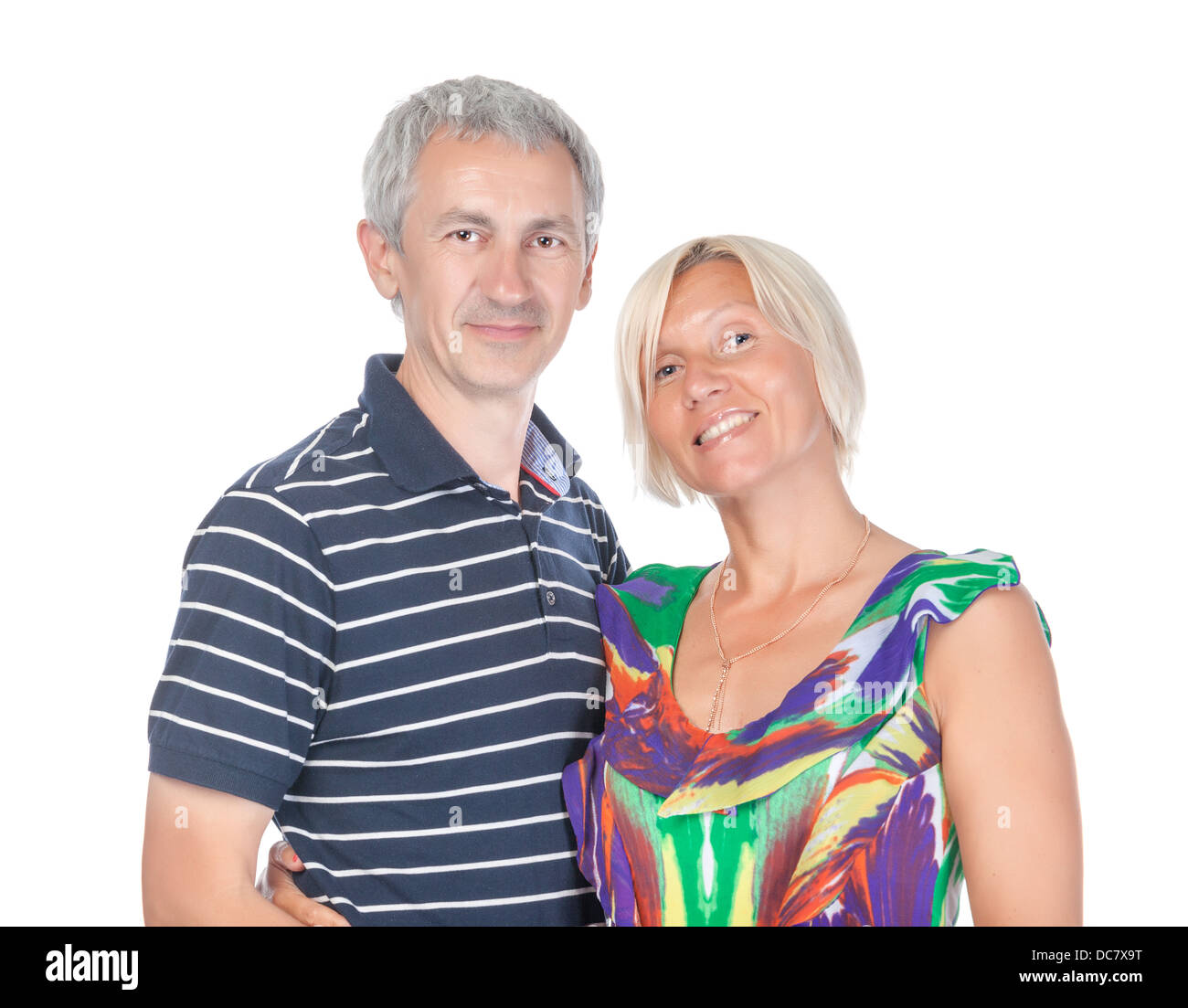 Smiling attractive middle-aged couple standing close together looking at the camera isolated on white Stock Photo
