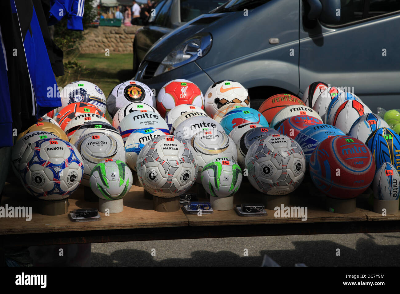 Footballs and Rugby on sale at a market stall Stock Photo Alamy