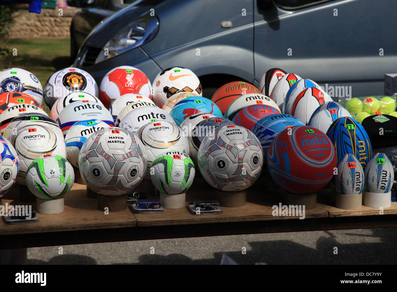 Footballs and Rugby on sale at a market stall Stock Photo Alamy