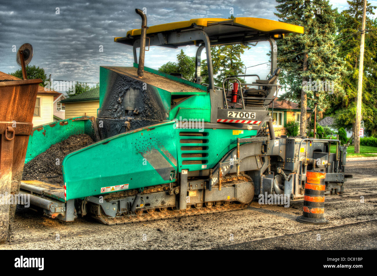 HDR photo of a Mini Paving Machine bethind an road stripper. Stock Photo
