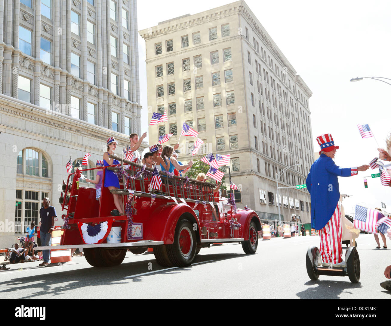 4th of July Independence day parade celebration in Greensboro, North Carolina, USA. Firetruck with waving flags and Uncle Sam. Stock Photo