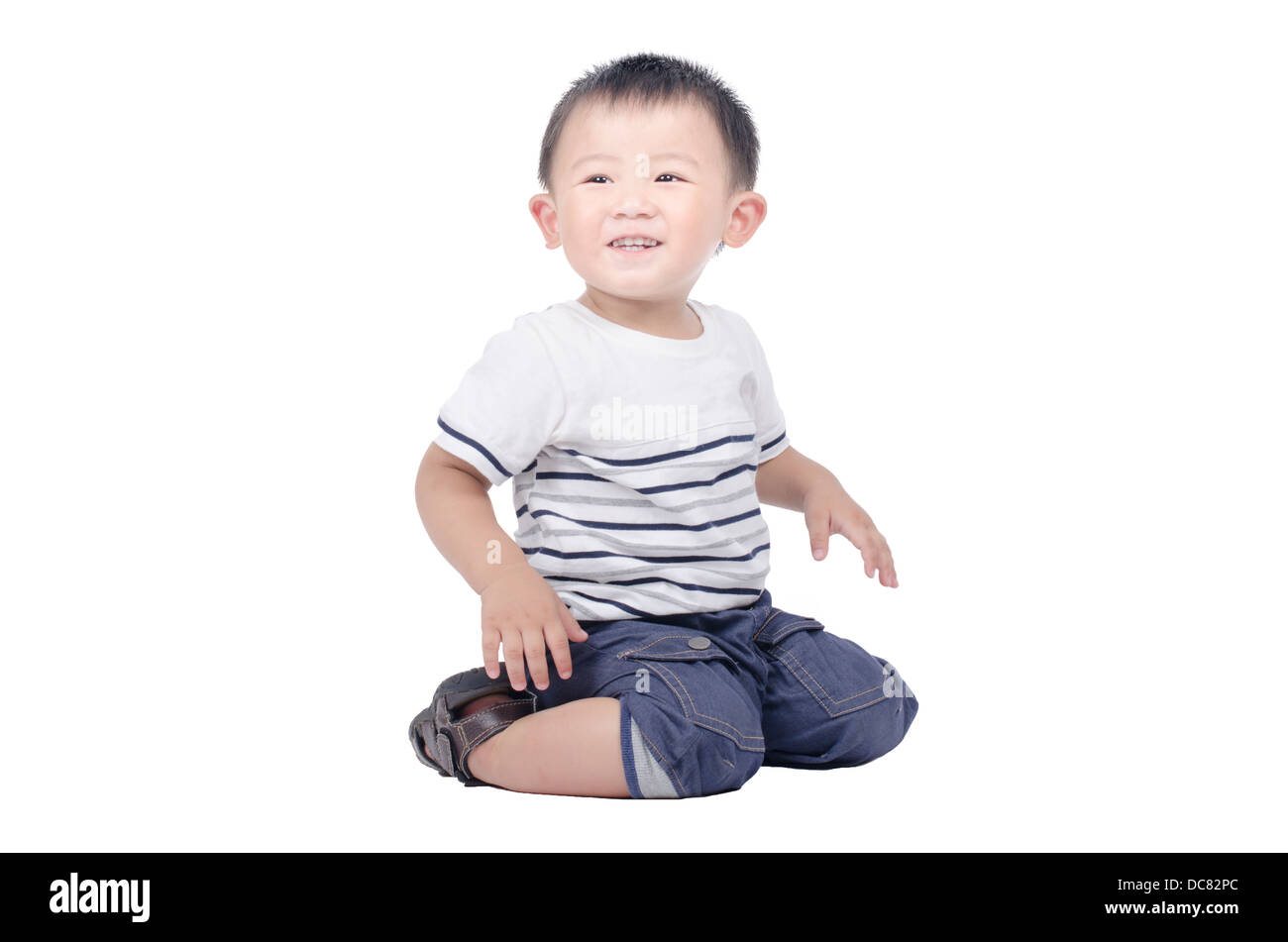 Smiling kid sit on the floor over white background Stock Photo