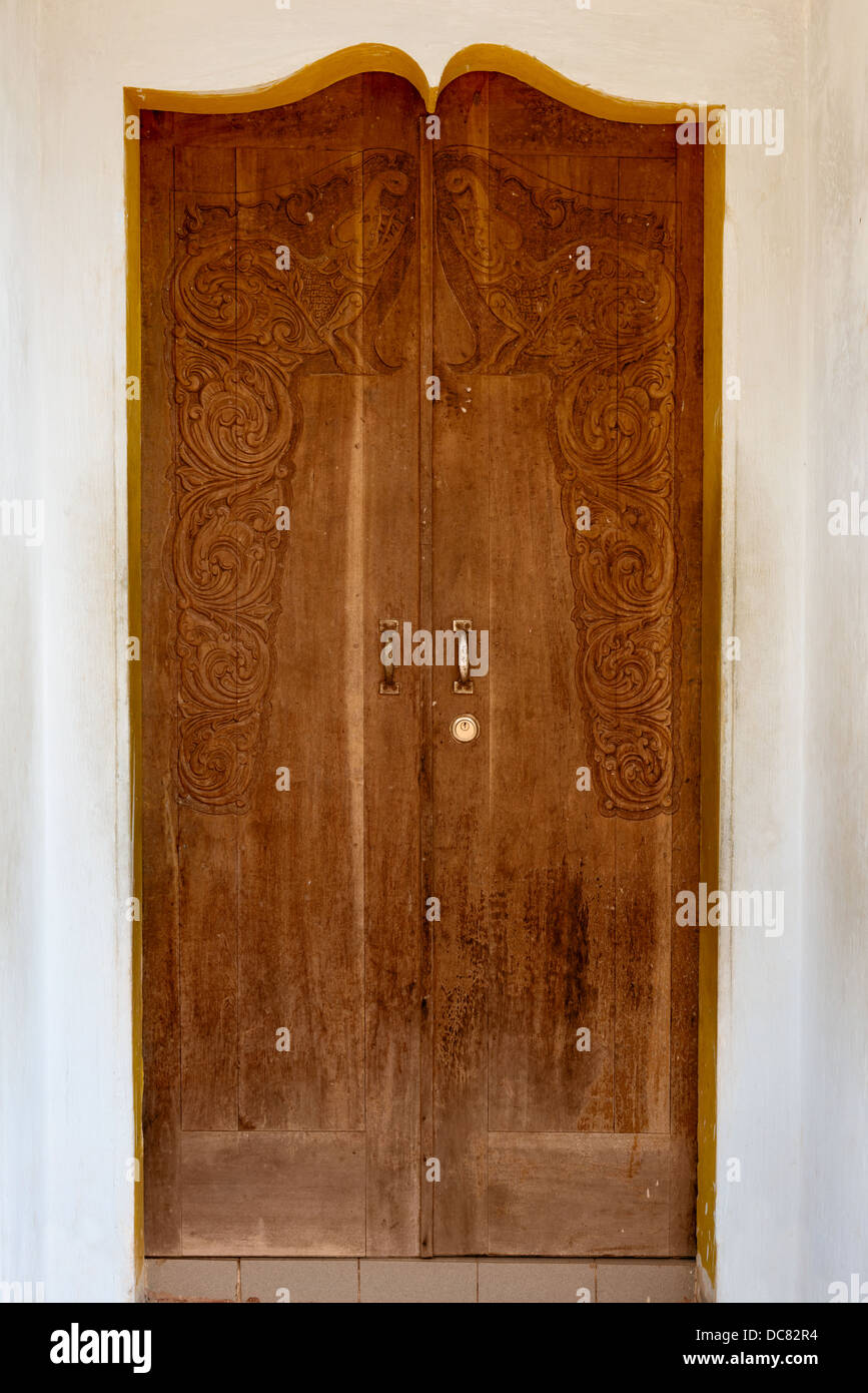 Old grunge wooden door with carving in arch Stock Photo Alamy