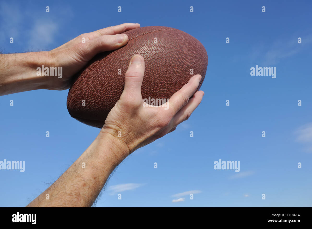 Catching / catcher / receiver holding an American football Stock Photo