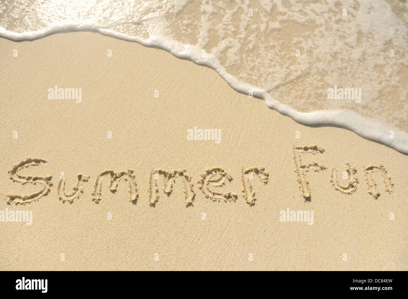 The Words 'Summer Fun' Written in the Sand on a Beach Stock Photo