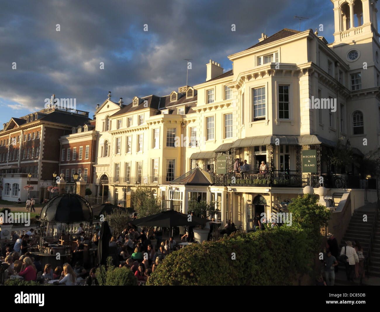 People enjoying a late summer evening relaxing at drinking in Richmond next to the Thames Stock Photo