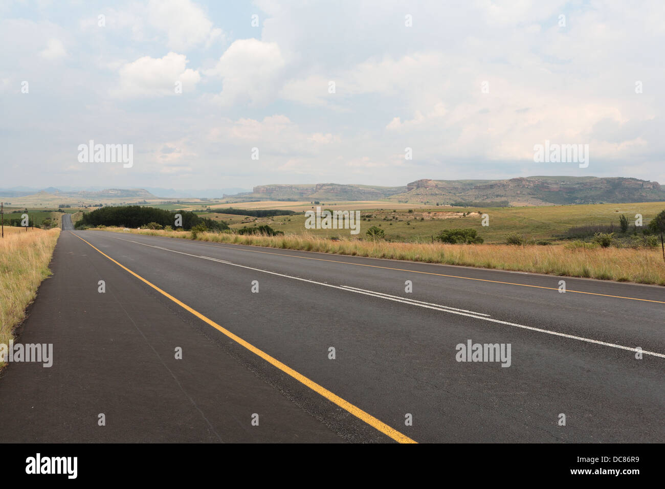 Road in the Maluti Route with distant mountain peaks, Orange Free State Province, South Africa Stock Photo