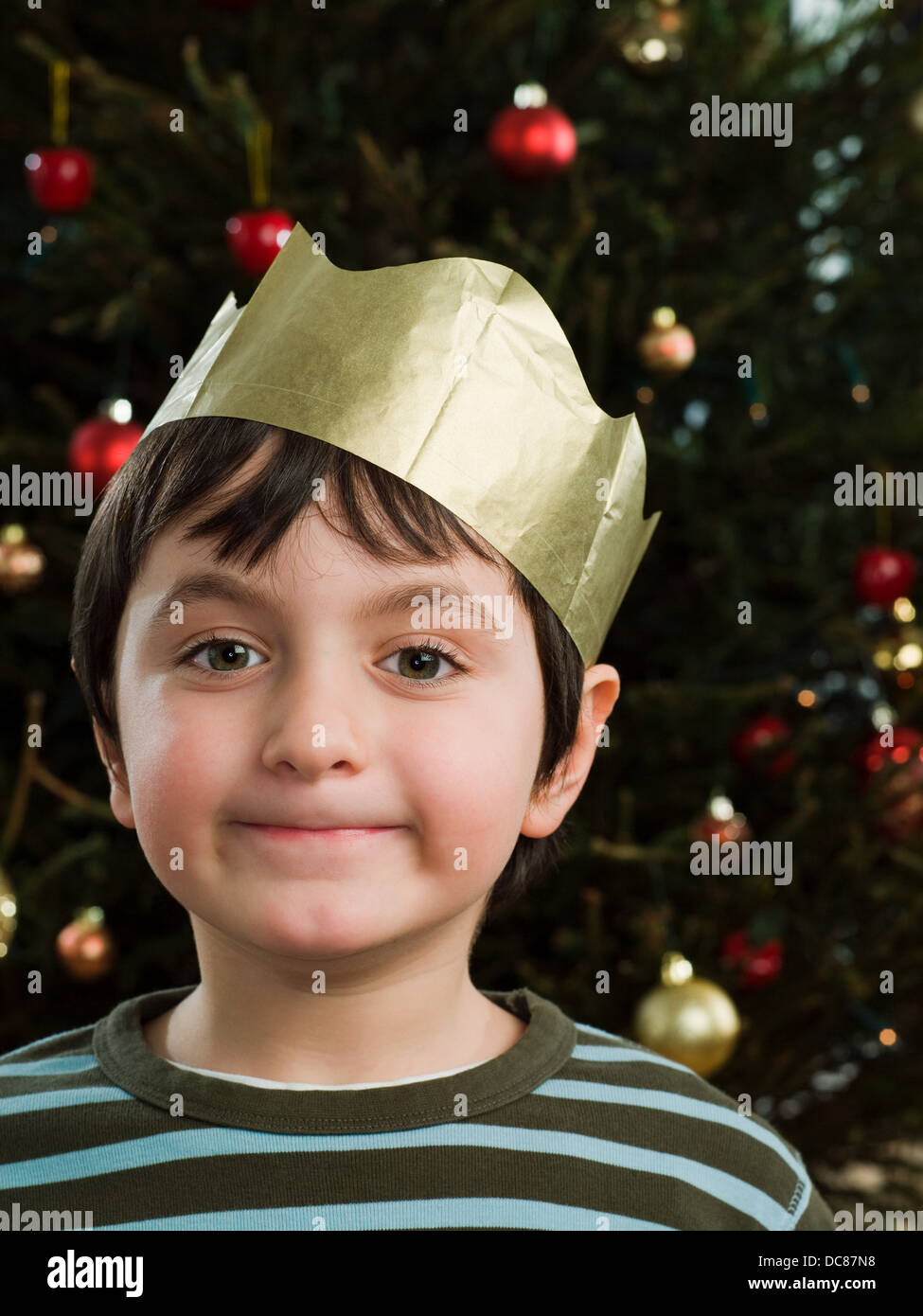 Grinning boy wearing a party hat Stock Photo Alamy