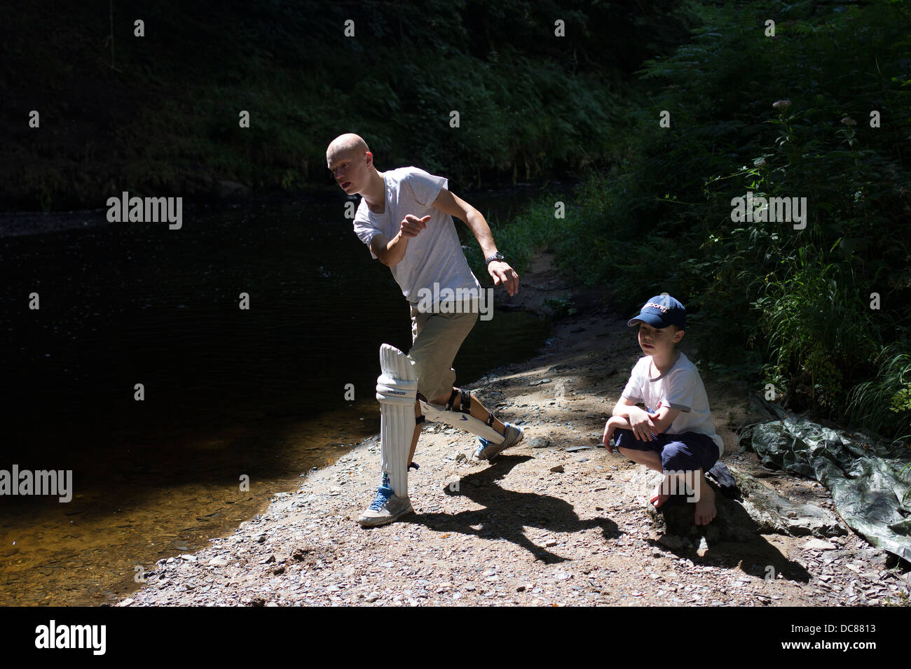 brothers skimming stones,river teign,cricket pads,balance,timing, active, activity, background, balance, blue, child, culture, e Stock Photo