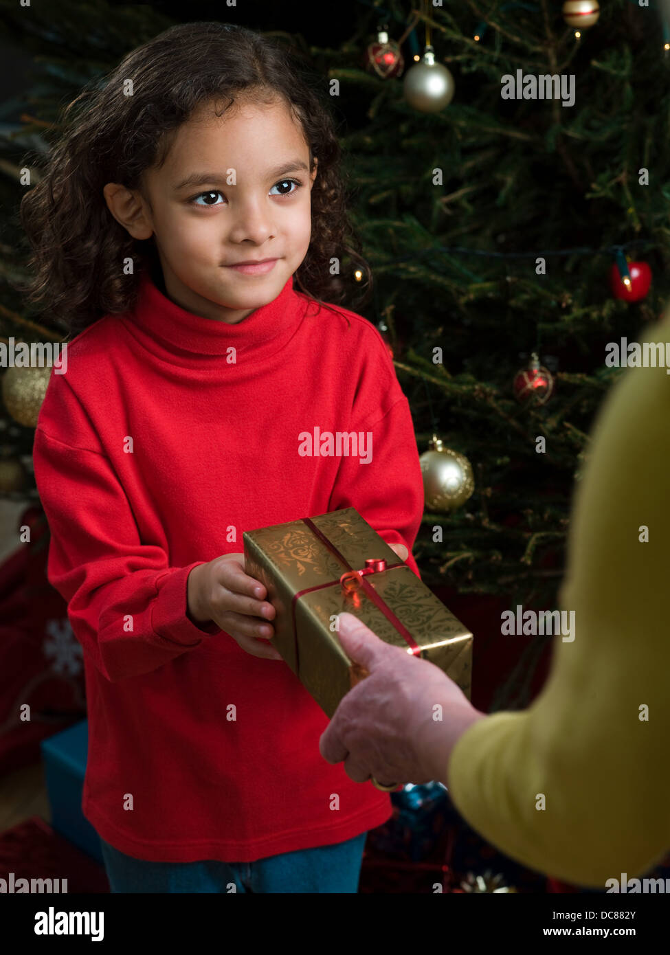girl receiving gift at Christmas Stock Photo