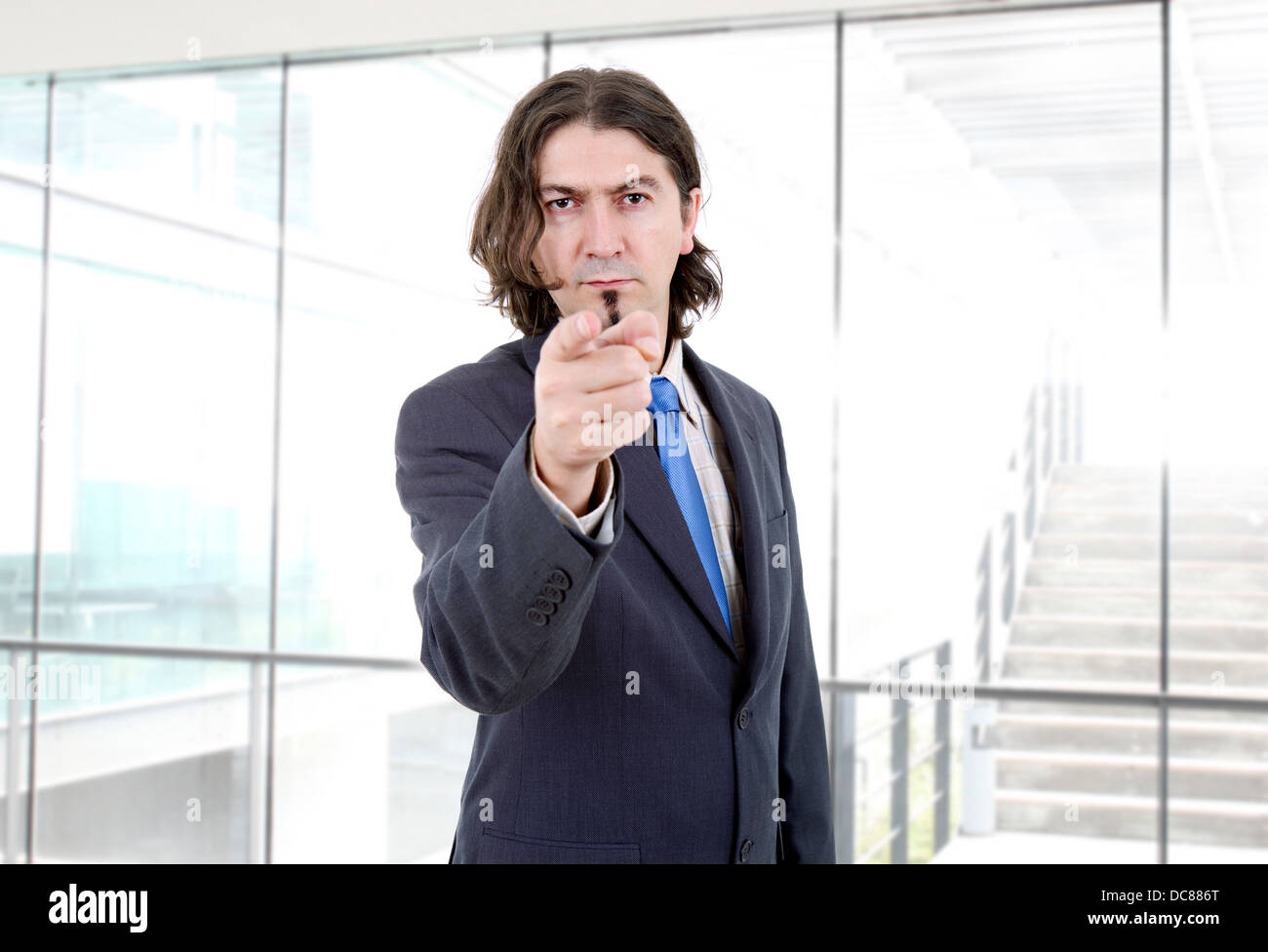 young business man in a suit pointing with his finger Stock Photo - Alamy