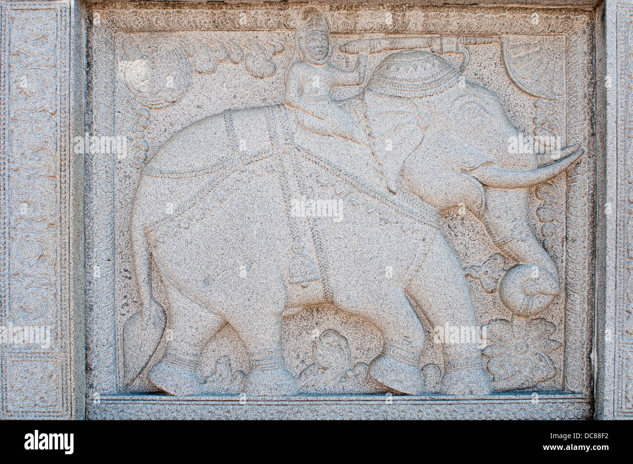 Stone carving with man riding elephant on a wall Duddhist Temple of the Sacred Tooth Relic in Kandy, Sri Lanka Stock Photo