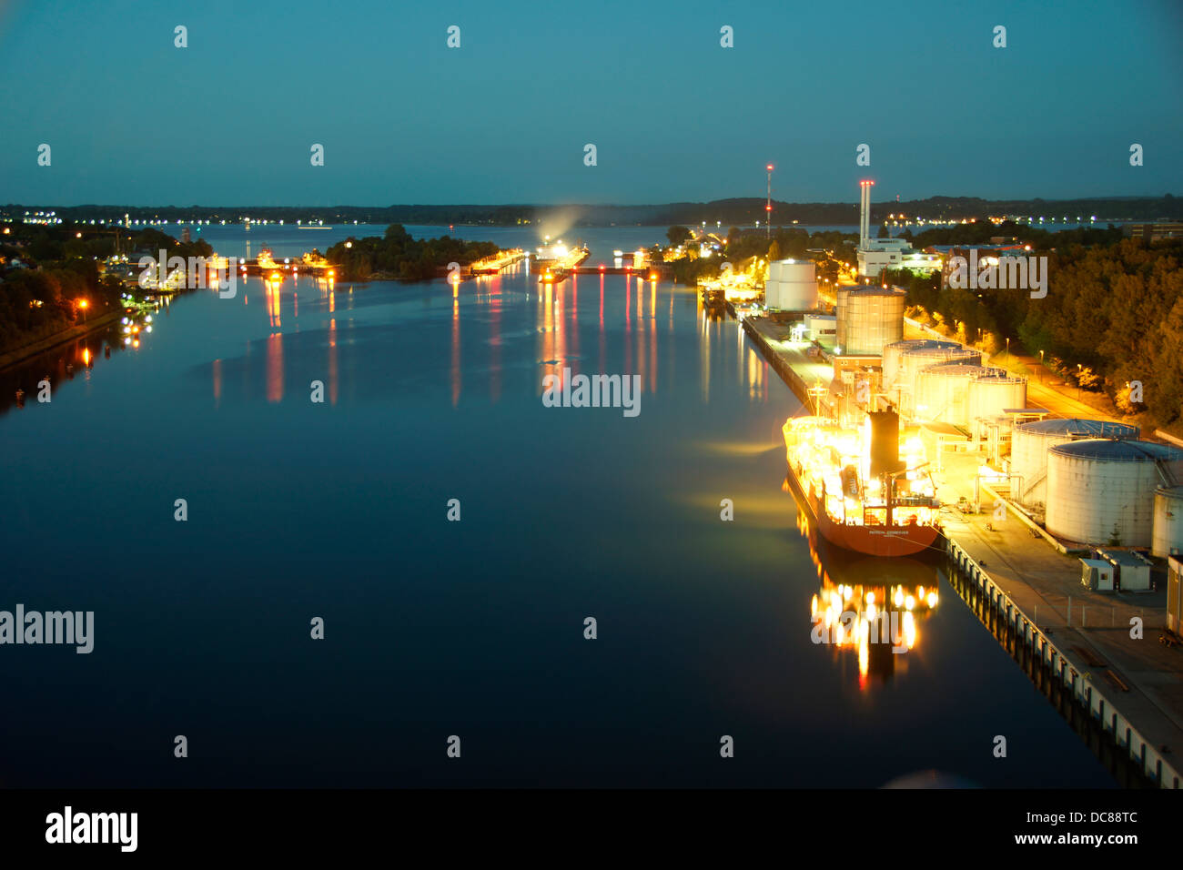 Long exposure of the canal lock KielHoltenau at night with a brightly lit ship Stock Photo