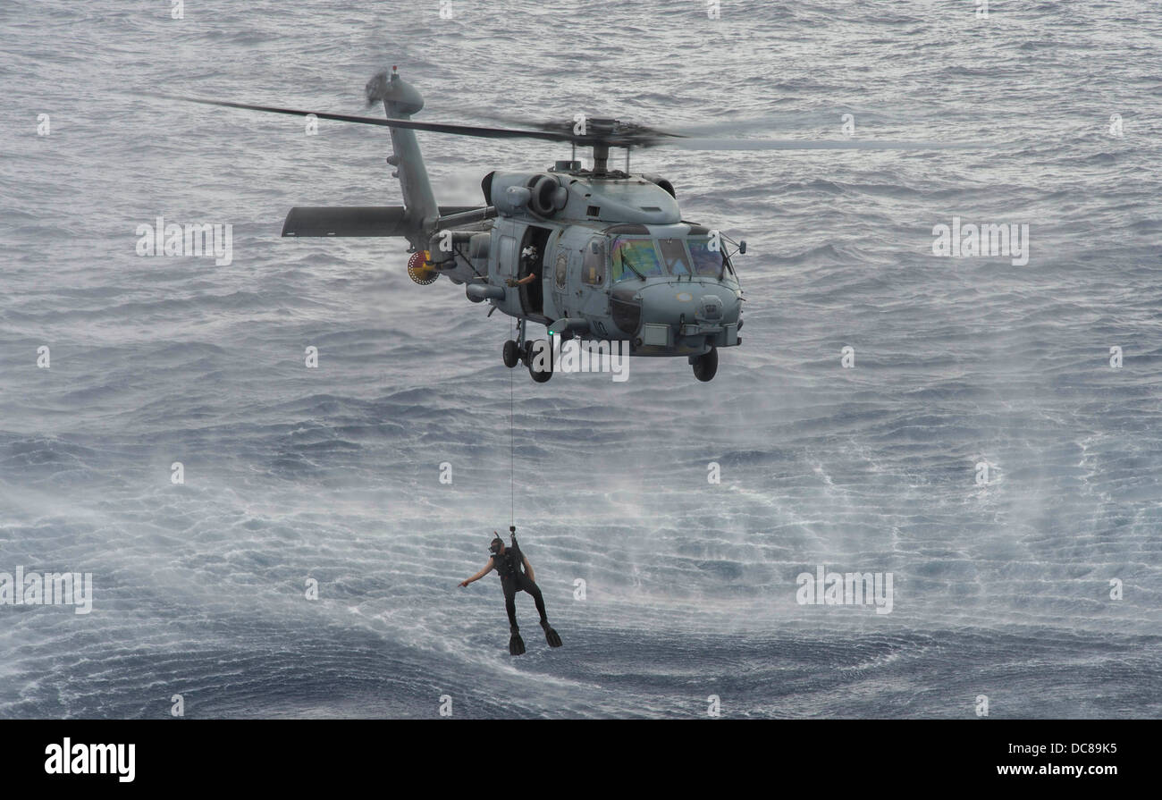 Navy Rescue A US Navy search and rescue swimmer prepares to rescue a simulated man ...