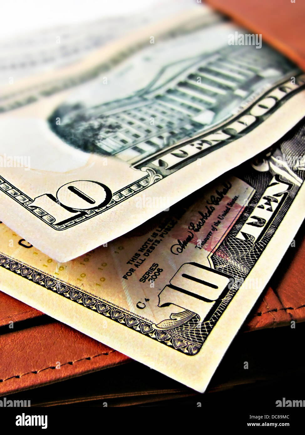 Ten 10 dollar bills cash - on a wallet - close up macro Stock Photo