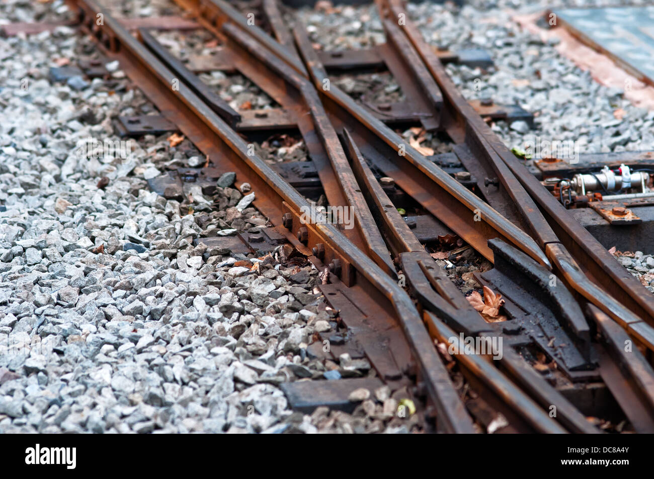 Old railway track rusty crossing gravel train line Stock Photo