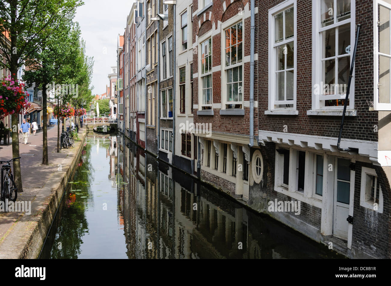 Canal along a road in Delft, Netherlands Stock Photo