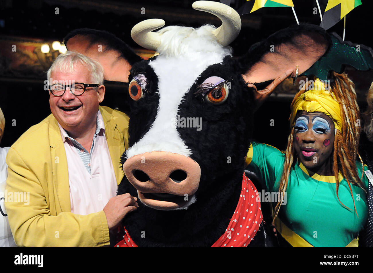 London UK 12th August 2013 : St Joseph's Hospice and Hackney Empire's Dame Dash Photocall with  Christopher Biggins (yellow jacket, along with a pantomime cow. Credit:  See Li/Alamy Live News Stock Photo