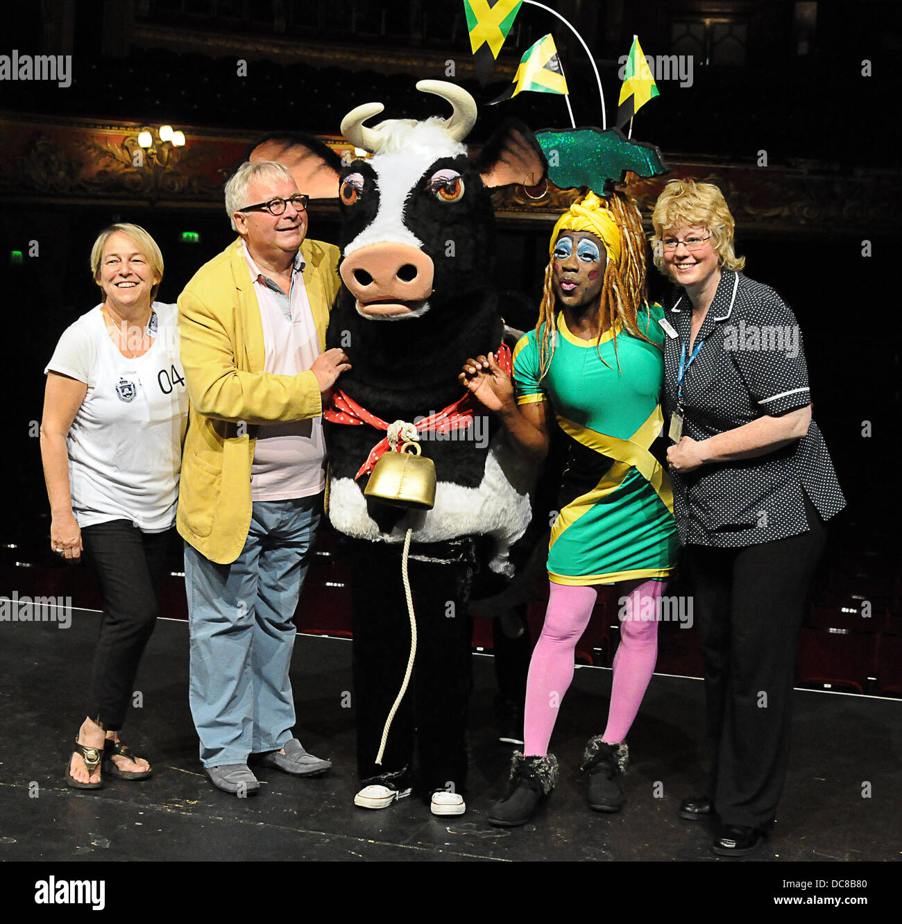 London UK 12th August 2013 : St Joseph's Hospice and Hackney Empire's Dame Dash Photocall with  Christopher Biggins (yellow jacket, along with a pantomime cow. Credit:  See Li/Alamy Live News Stock Photo