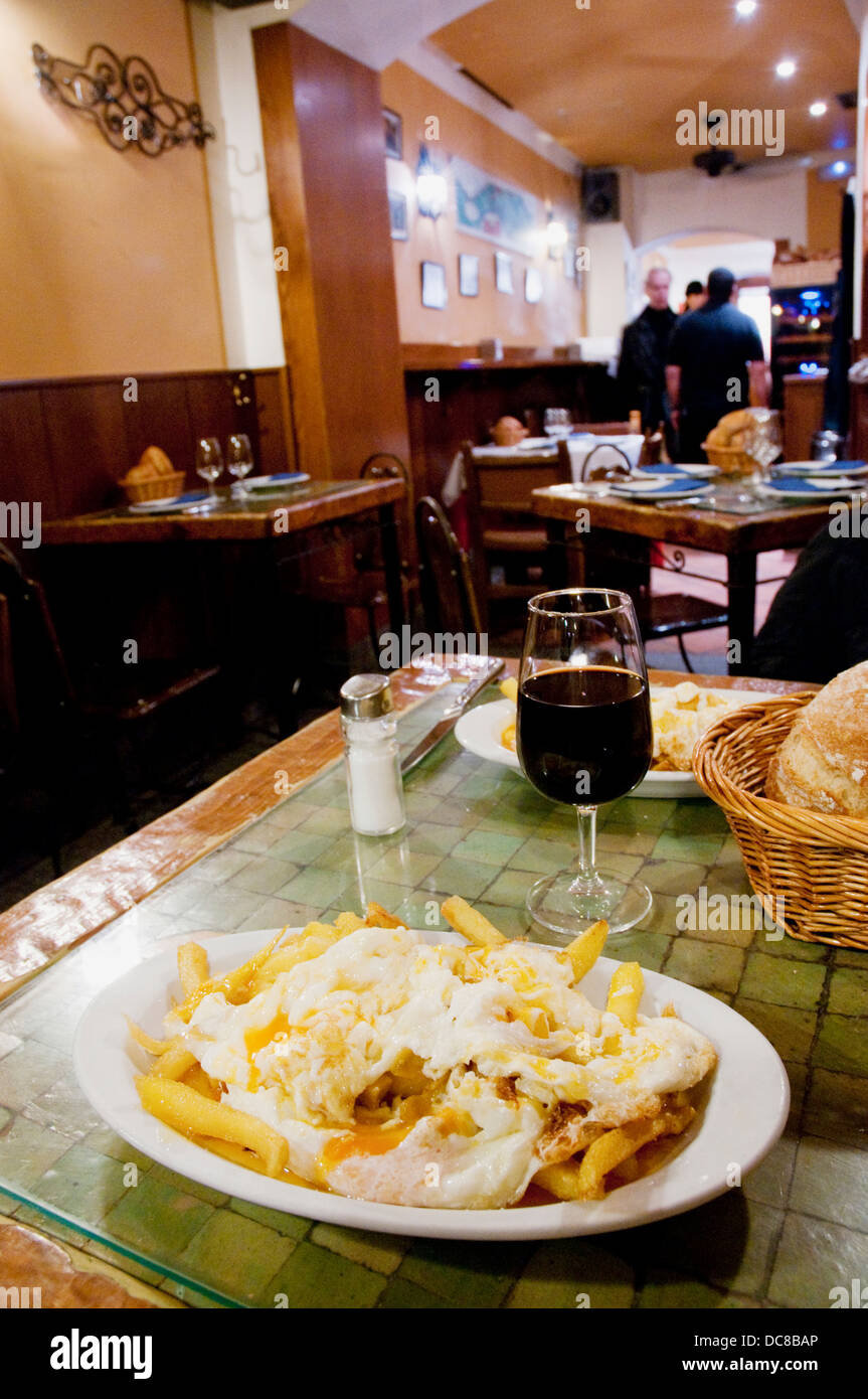 Huevos rotos serving at Los Huevos de Lucio tavern. Madrid, Spain. Stock Photo