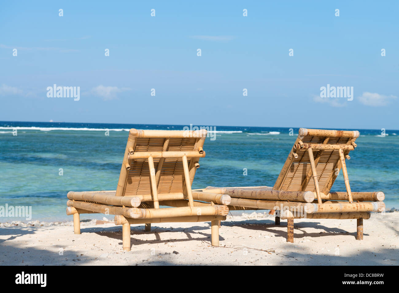 Tropical seascape with bamboo beach beds under blue sky Stock Photo Alamy