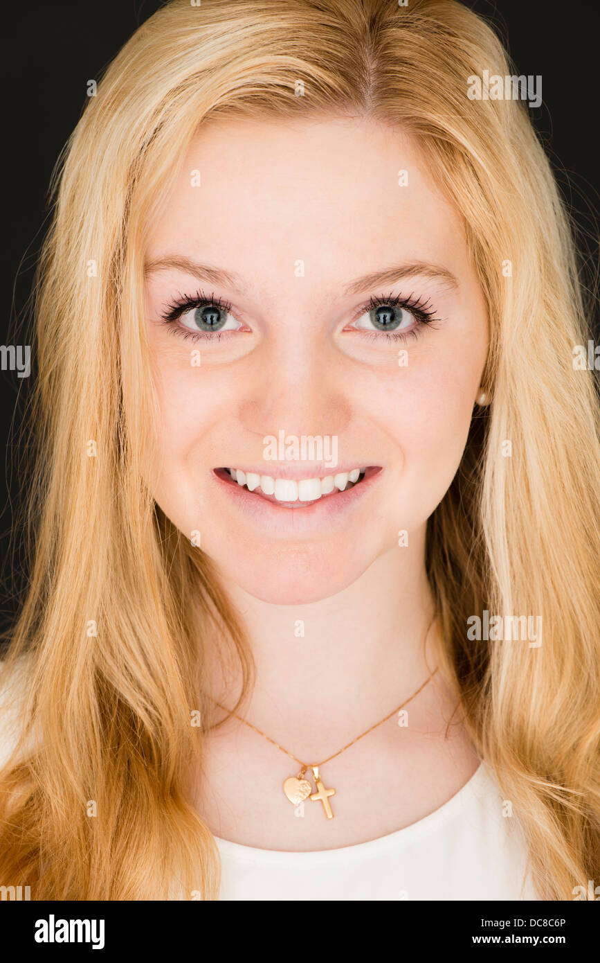 Portrait of young blond female teenager looking at camera and smiling Stock Photo
