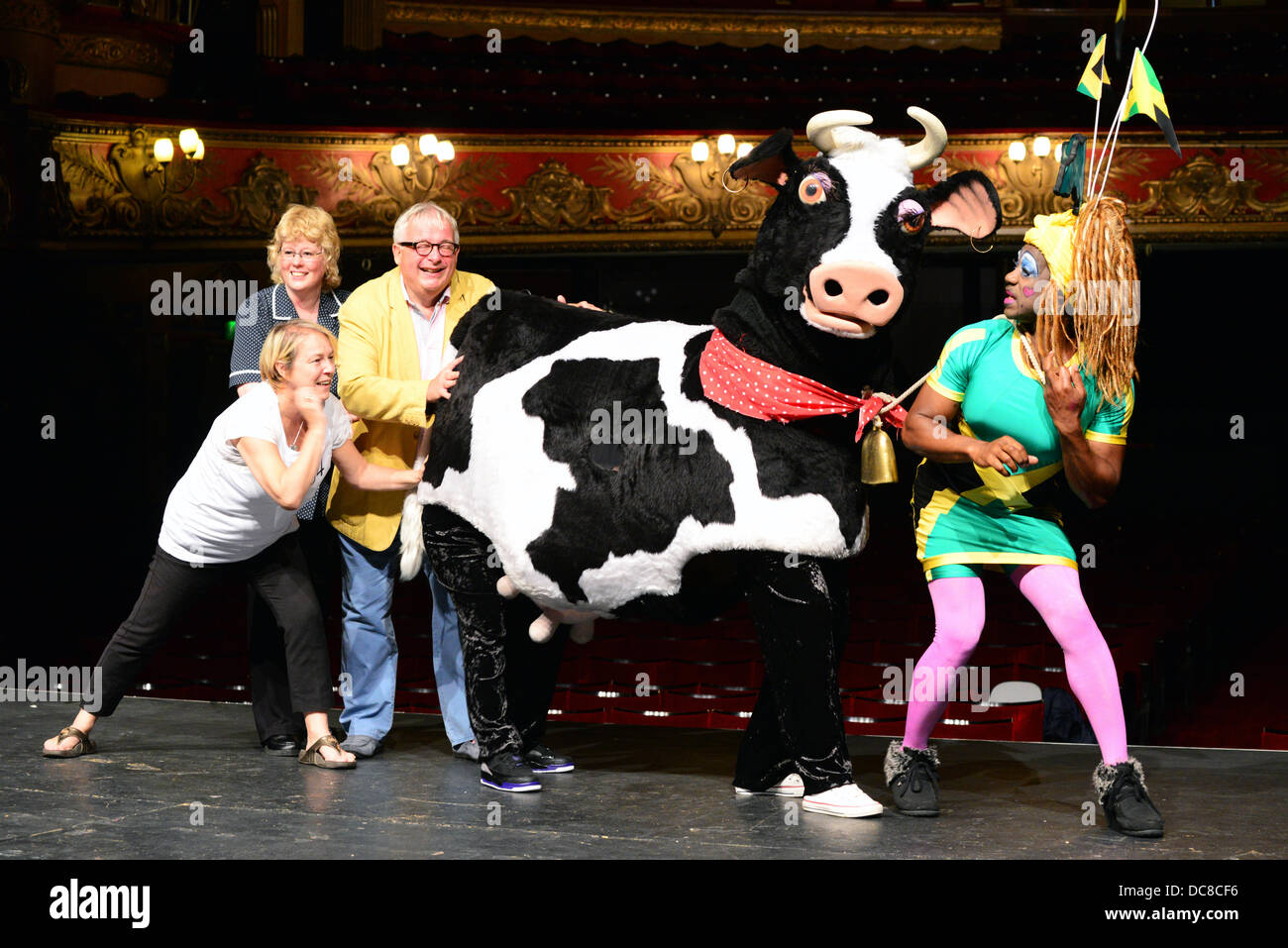 London UK 12th August 2013 : St Joseph's Hospice and Hackney Empire's Dame Dash Photocall with Christopher Biggins (yellow jacket, along with a pantomime cow. Credit:  See Li/Alamy Live News Stock Photo