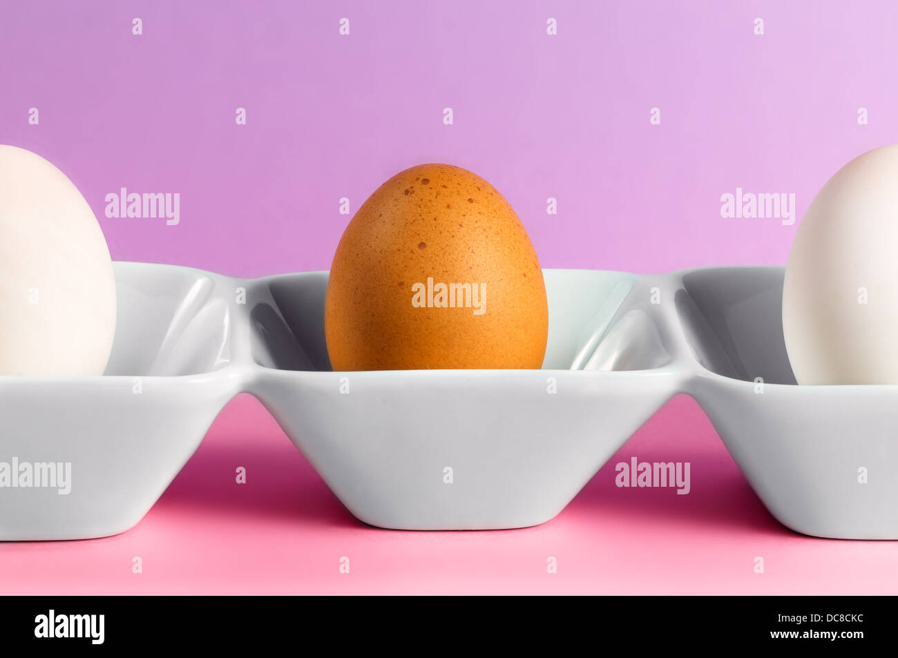 An egg and two halves standing on a dish Stock Photo