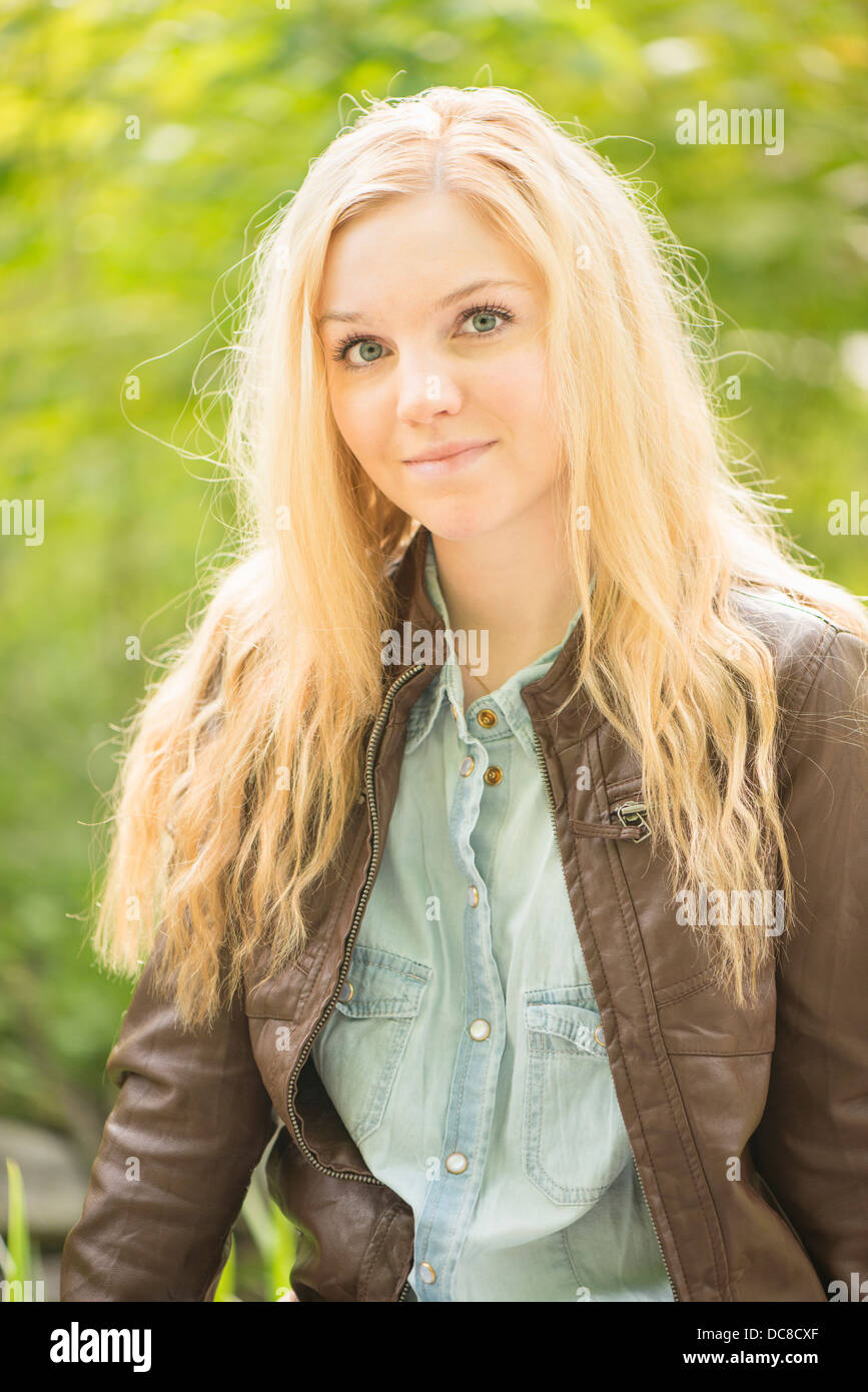Nature scene with one young attractive blonde woman in a park Stock Photo
