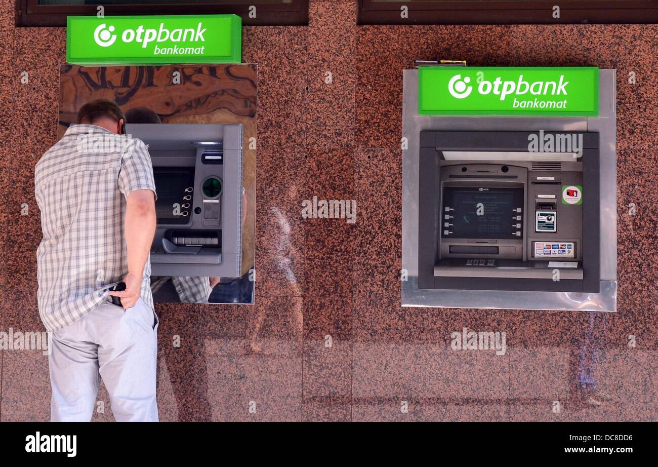 A man withdraws money from a cash machine of Hungarian OTP Bank in Budapest,  Hungary, 05 August 2013. The OTP Bank is the biggest Hungarian Bank and  active in Hungary as well