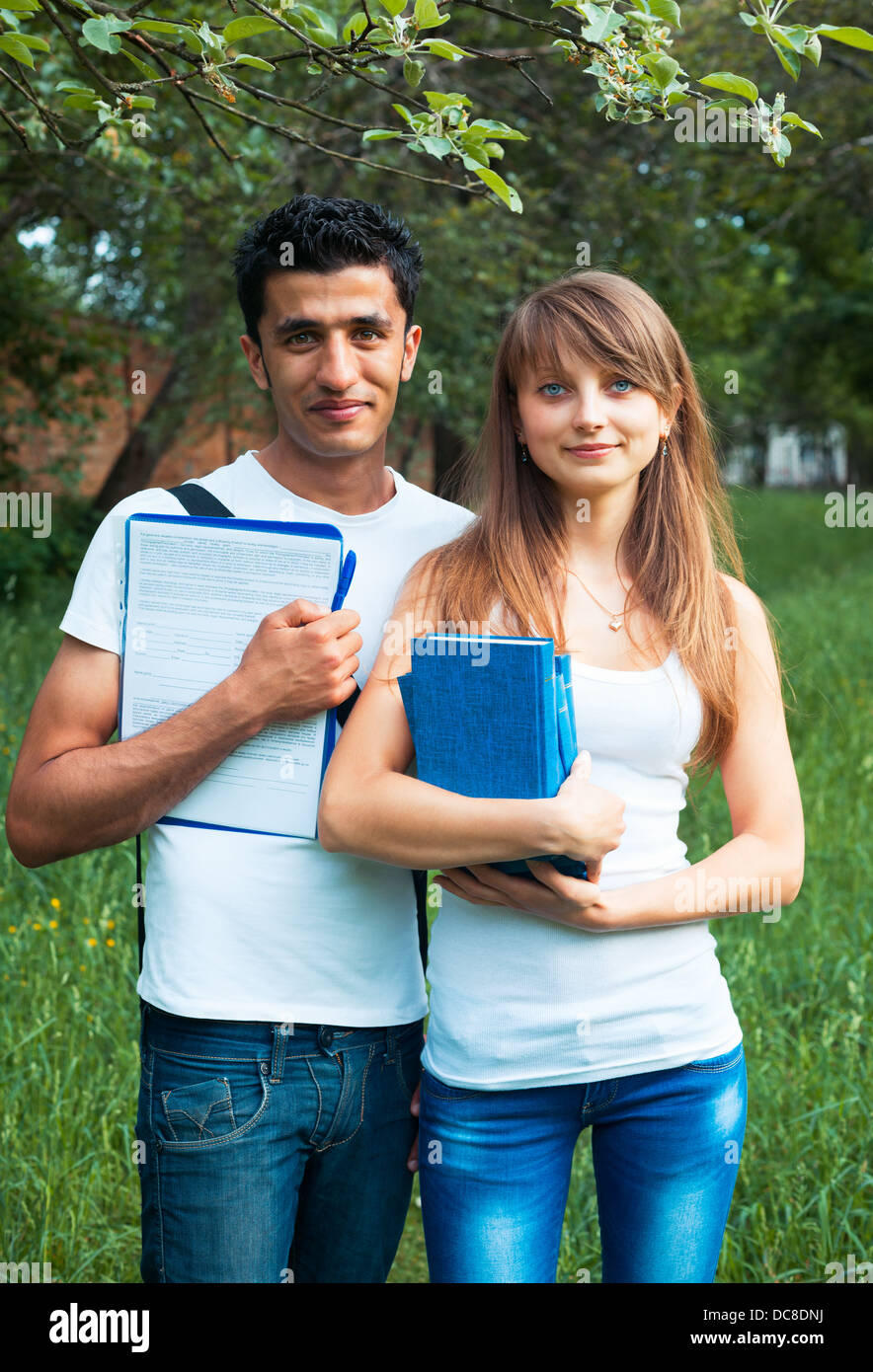 Two students guy and girl studying in park with book outdoors Stock Photo