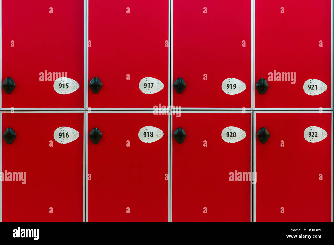 Red doors with numbers and locks in the locker room Stock Photo