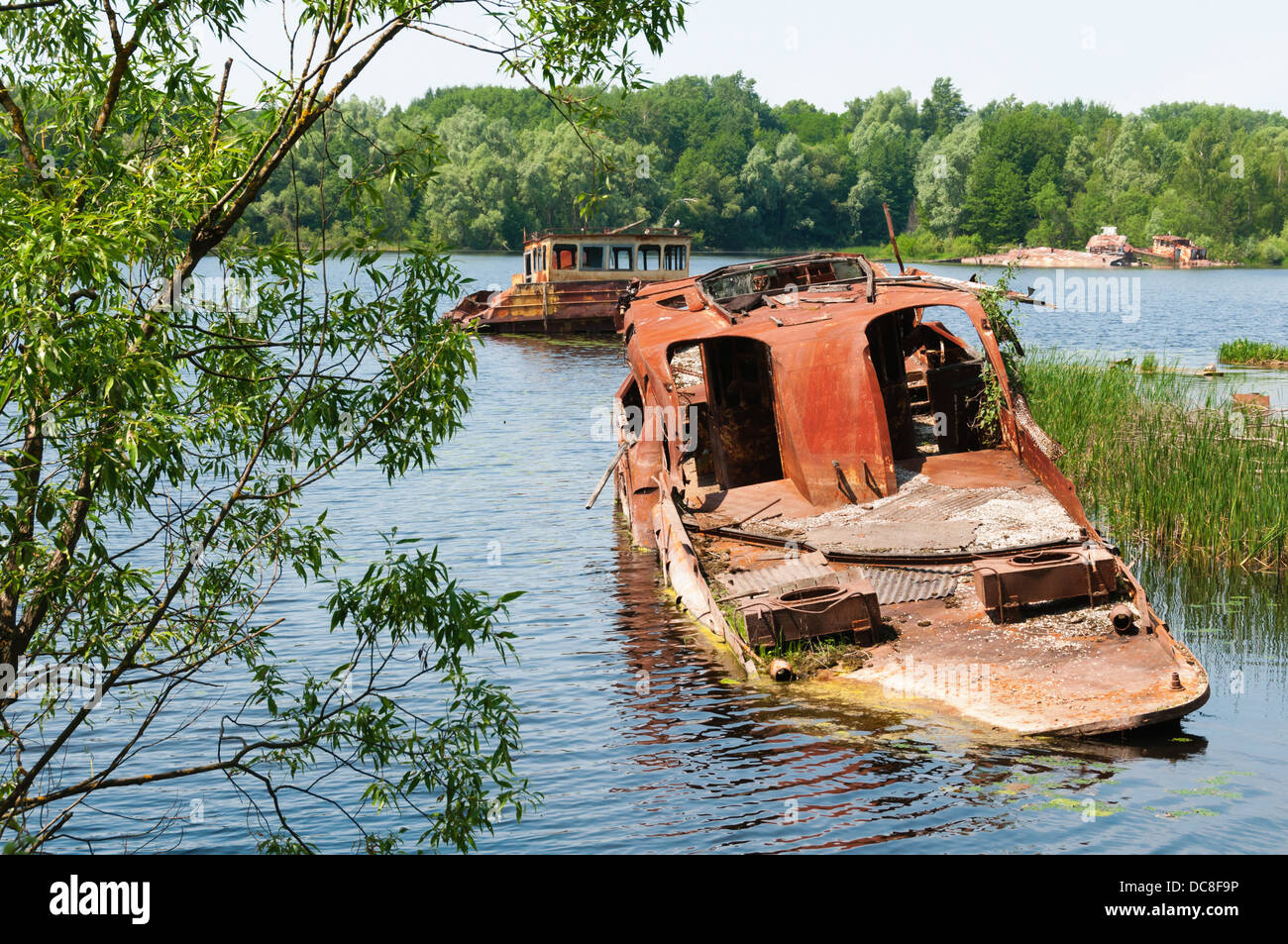 Wrecked abandoned ships on a river after nuclear disaster in Chernobyl, Ukraine Stock Photo