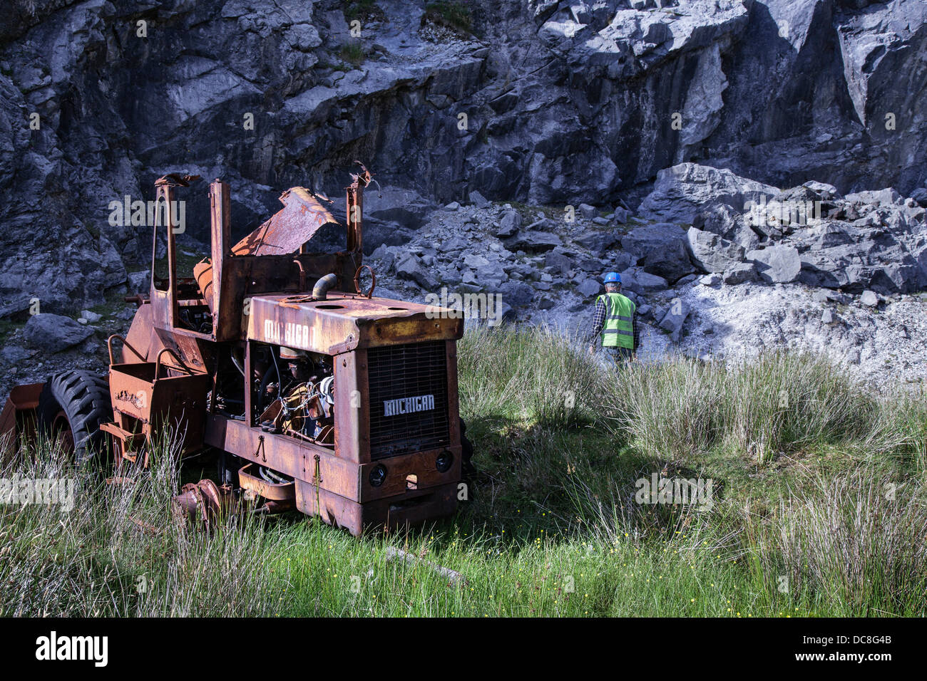 Rock outcrop and Bla Bheinn and Beinn Na Caillich Cuillin mountains; Geologist at Loch Slapin Marble quarry at Ben Suardal, Isle of Skye, Scotland, UK Stock Photo