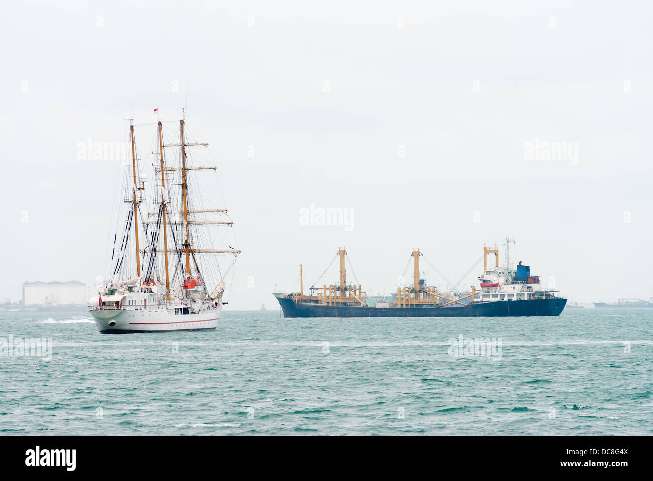 Sailing vessel ship and oil tanker on the sea near a port Stock Photo
