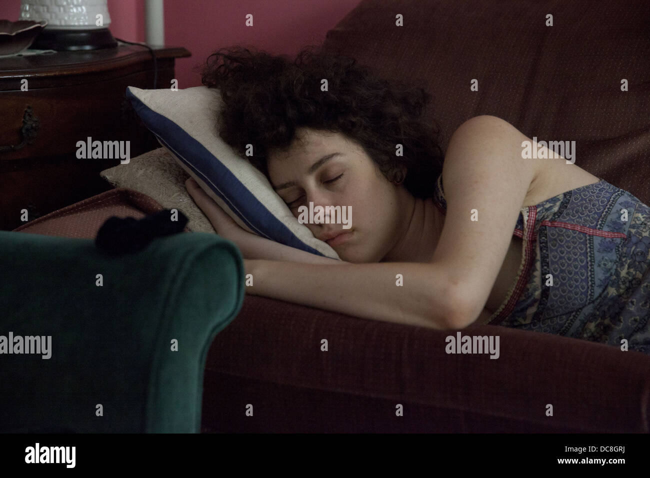 Young woman naps on her couch at home in New York City. Stock Photo