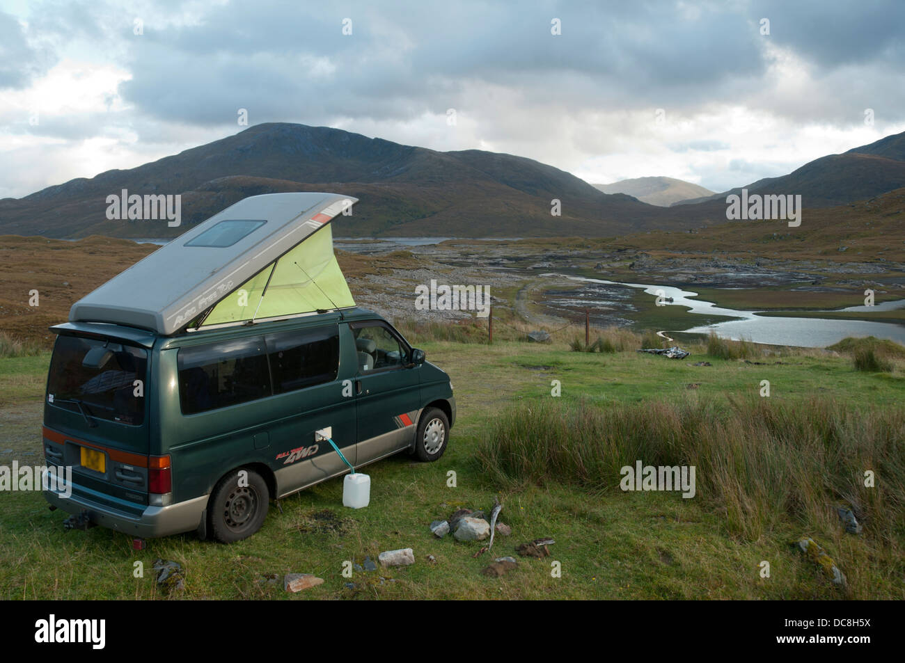 Mazda Bongo motor home camped by the shore of Loch Quoich,  Highland Region, Scotland, UK Stock Photo