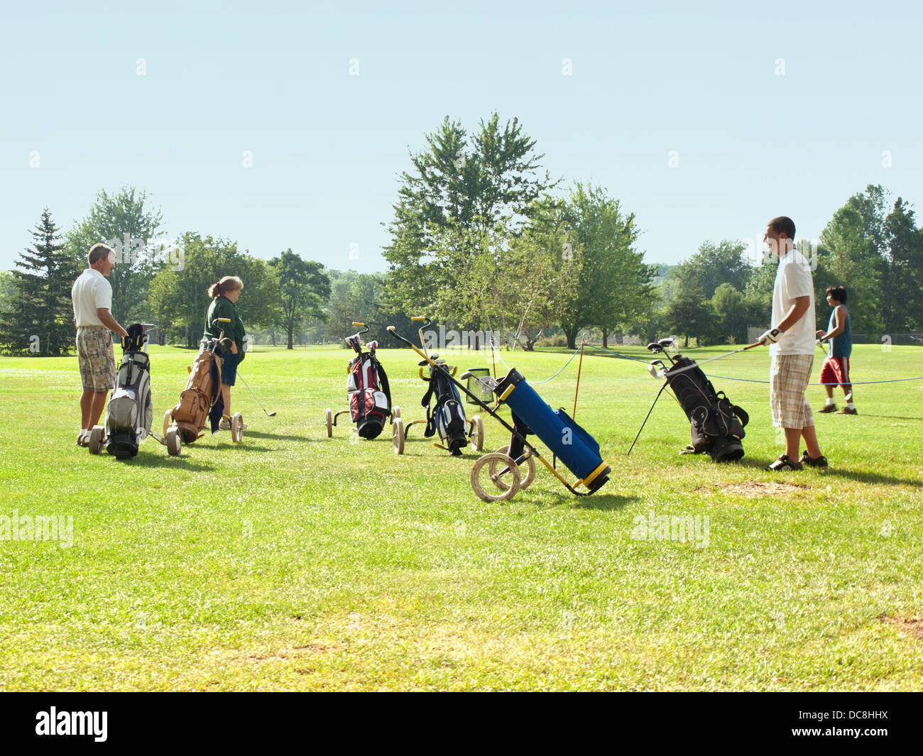 people getting ready to play a game of golf Stock Photo