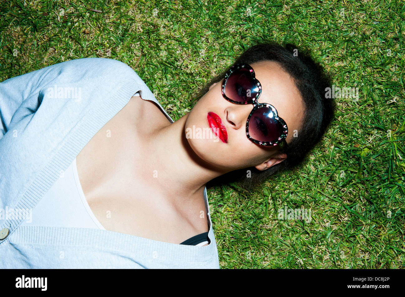 Young girl lying on the grass Stock Photo