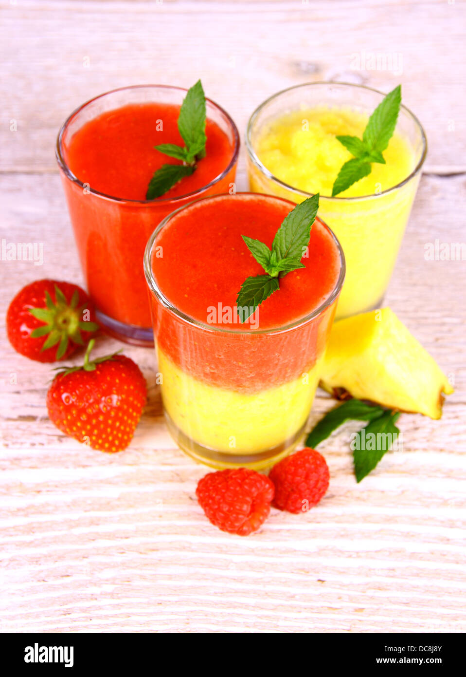 Raspberry, strawberry and pineapple smoothie in glass mixed, top view Stock Photo