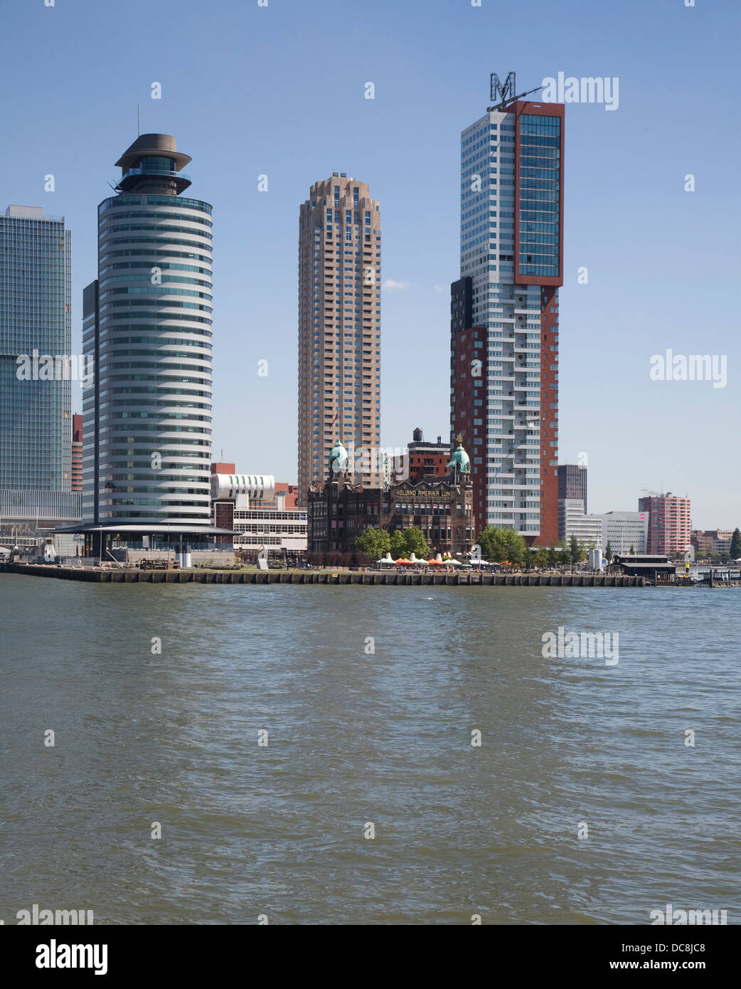 Hotel New York dwarfed by modern high rise buildings Rotterdam Netherlands Stock Photo