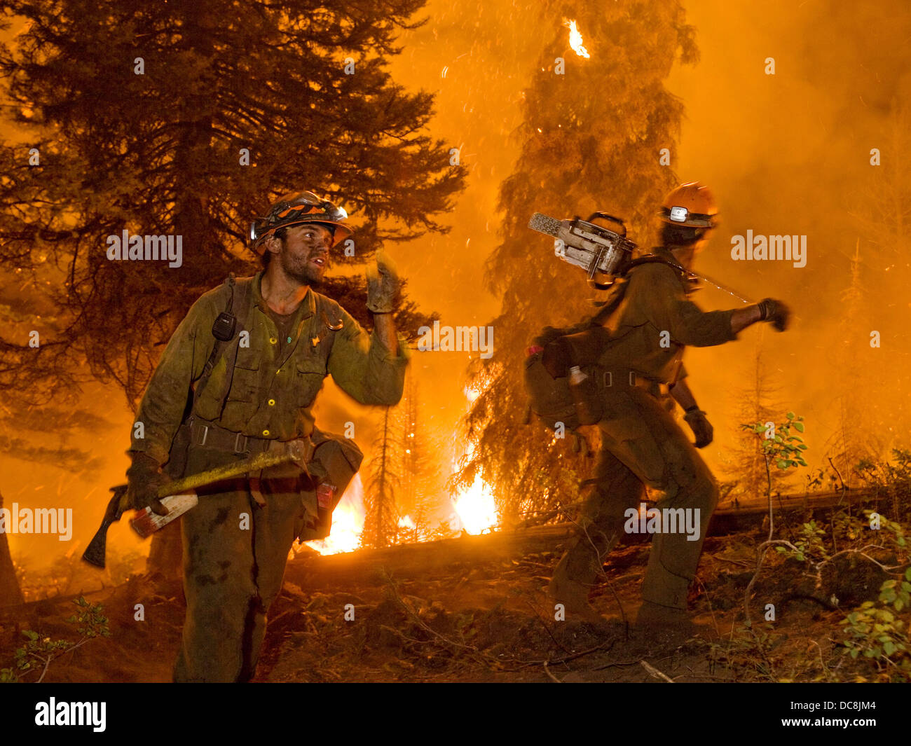 Two members of the Idaho City Hotshots work on the Springs Fire on the Boise National Forest August 13, 2012 near Boise, ID. Hotshot crews have been extensively trained to fight fires in remote areas with little or no logistical support in the most demanding conditions. Stock Photo