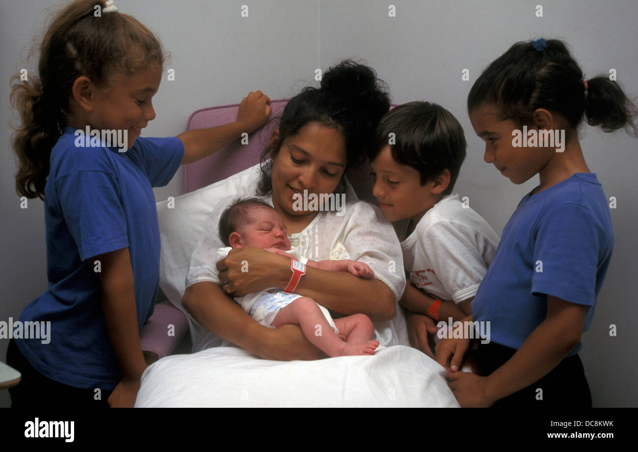 siblings surrounding Hispanic mother with her newborn baby in hospital  Stock Photo - Alamy, image size:1300x920